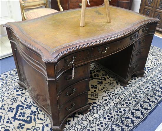 A serpentine pedestal desk, 135cm wide